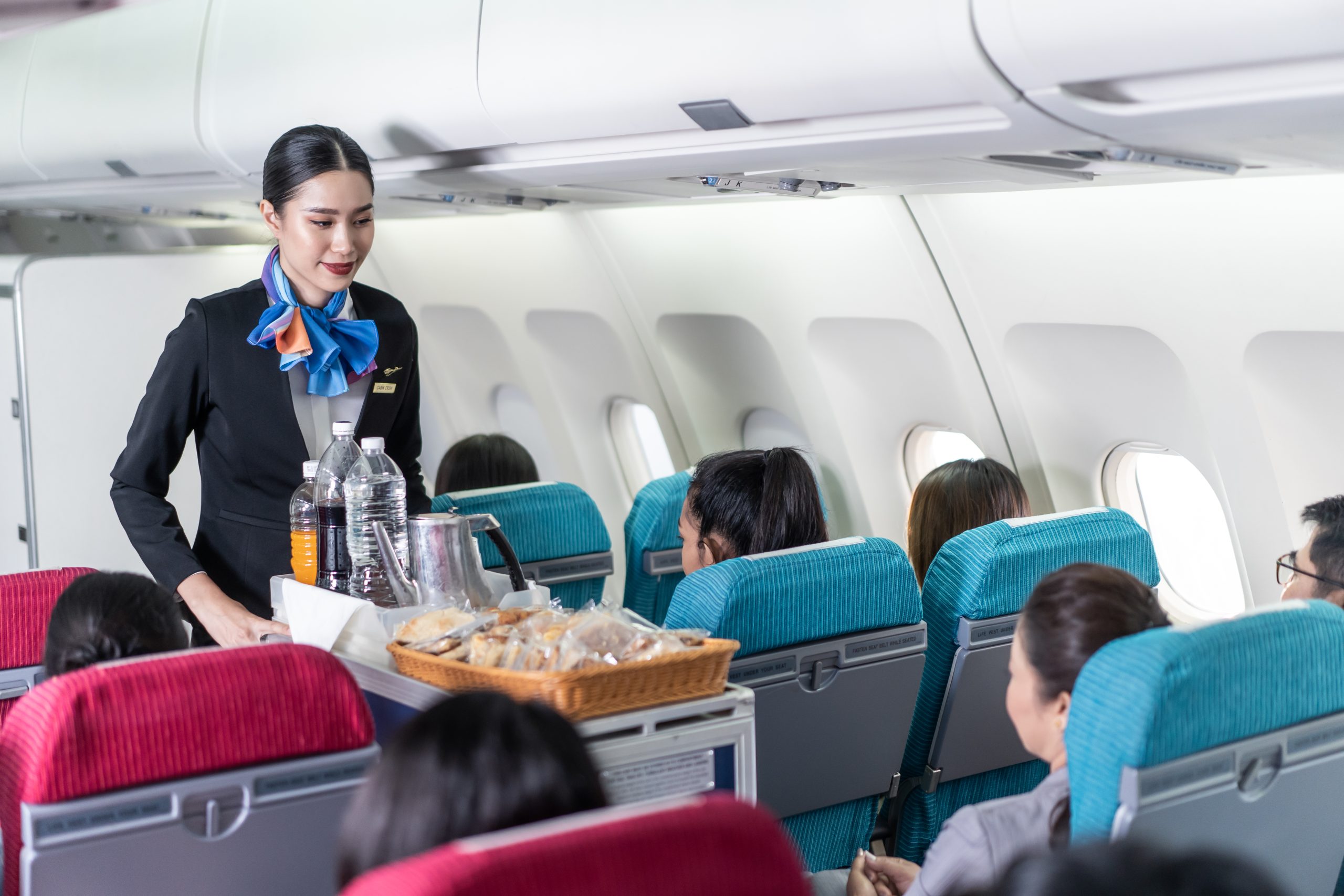 Female Cabin Crew Attending Passengers